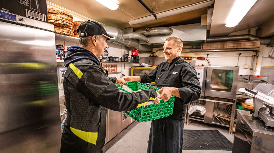 Action delivery man. Driver Stig André Madsen easily unhitches trailer and tractor unit, making delivery a few minutes later to Dag Steinar Fredriksen Myklebust, Anker Brygge restaurant chef.
